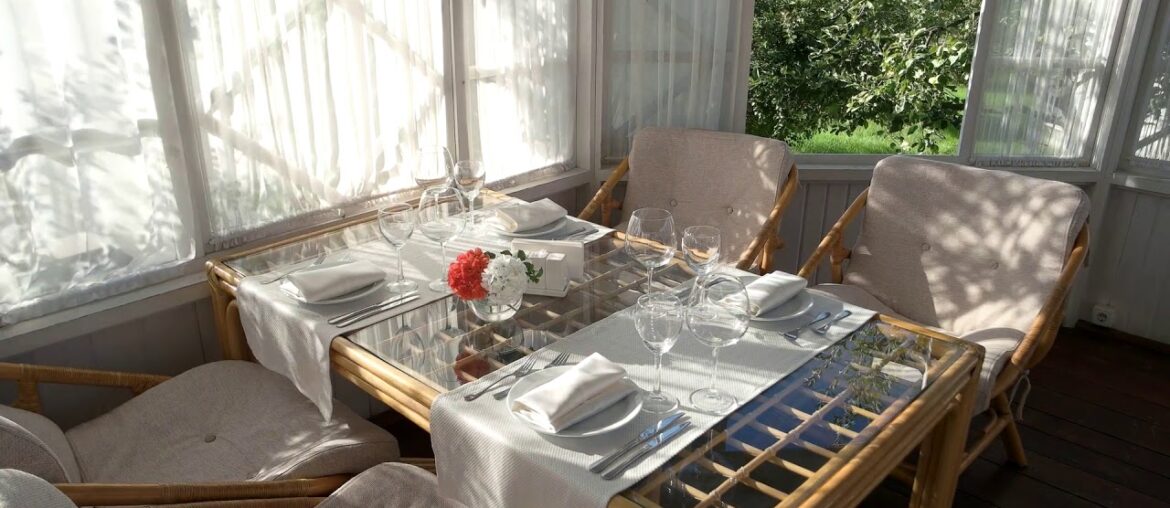 dining table near opened window empty glasses and plates