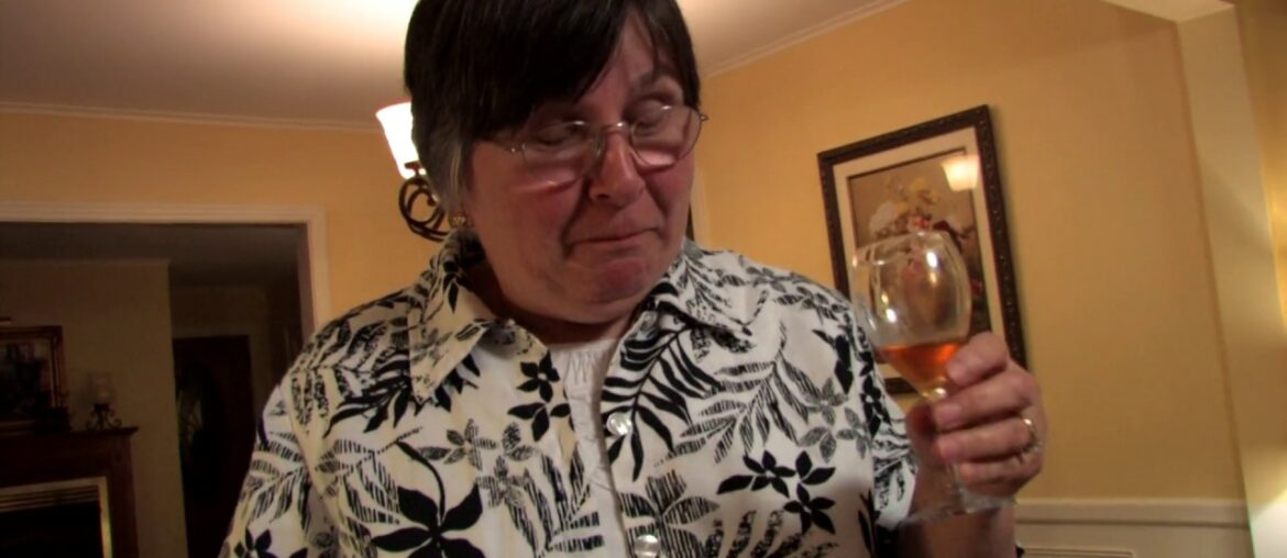 Mary French tastes Uncle Leory Eldridge's plum wine in Murray, Kentucky