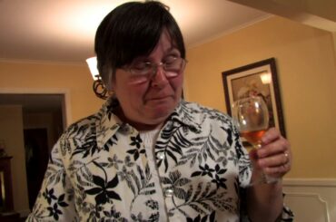 Mary French tastes Uncle Leory Eldridge's plum wine in Murray, Kentucky