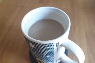 French vanilla coffee cooling in mug on dining table