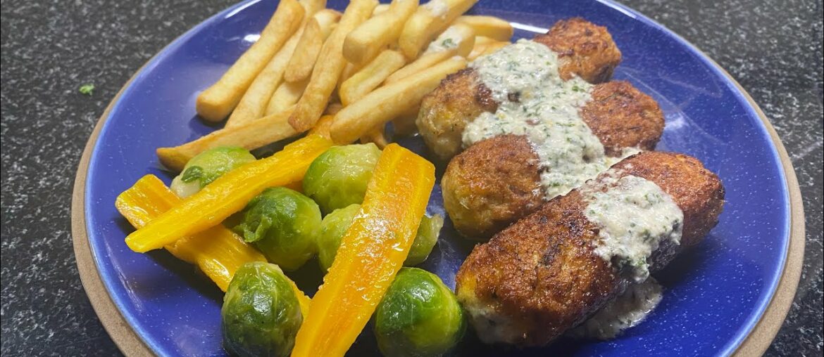 Chicken rissoles in parsley sauce with French fries and veg