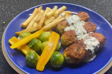 Chicken rissoles in parsley sauce with French fries and veg