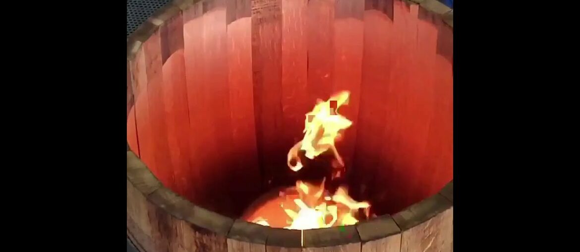 Toasting wine barrel slo-mo at Tonnellerie Cadus in Burgundy, France.