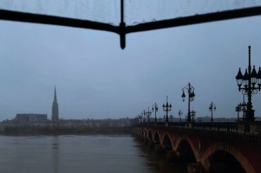 Walking on the rainy old stone bridge, transparent umbrella, Bordeaux, France 4K / DEC 21 2020