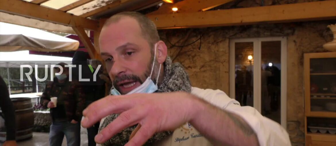 Restaurateur leads supporters in march against COVID measures after backing down on reopening