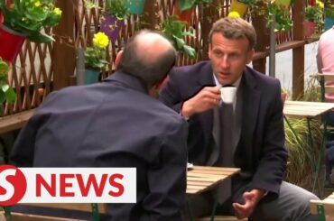 France's Macron out in the cafe after Covid-19 restrictions are eased