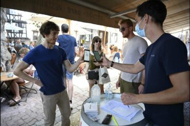 Despite weeks of protests France implements health pass at cafes and