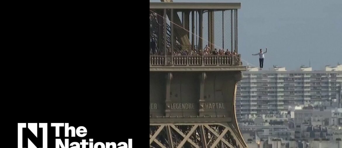 French daredevil walks a 70-metre high slackline from the Eiffel Tower