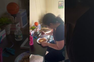 Emily is eating a French toast listening to music and drinking a sprite