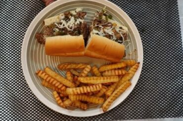 Cheesesteak sandwiches with peppers, onions and mushrooms