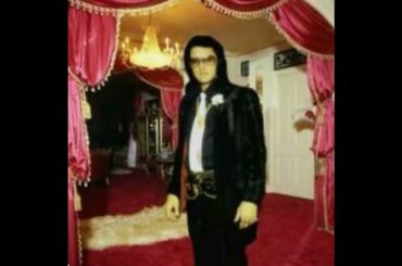 Elvis Standing By The Dining Room ,Foyer Area Of Graceland.Notice The Red Decor.