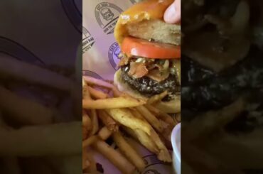 Juicy burger with over the top toppings n french fries n mango chutney