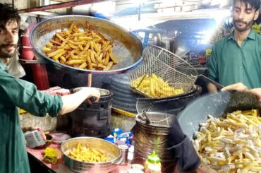 A Young Handsome Guy making Crispy French Fries like McDonald and KFC Fries at street food Pakistan