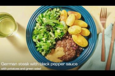 German steak with black pepper sauce with potatoes and green salad