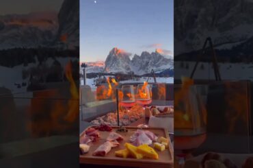 Toast to the Alps: Enjoying a Glass of Wine with a Breathtaking View and a Warm Fire. Want to Join?