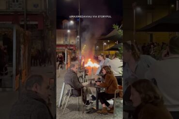 French diners eat calmly amid firey protest