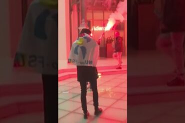 French protesters light flares while storming investment firm