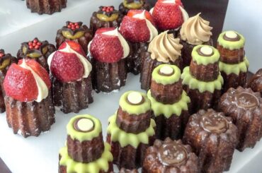 French "Caneles" Sweet Pastries from Bordeaux Seen and Tasted in Partridges Market. Street Food