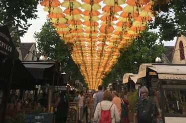 Experience walking under the umbrellas of Bercy Village Paris ,France