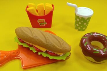 Toy sandwich, donuts, cake, juice, french fries. Toy food for kids. Fun play.