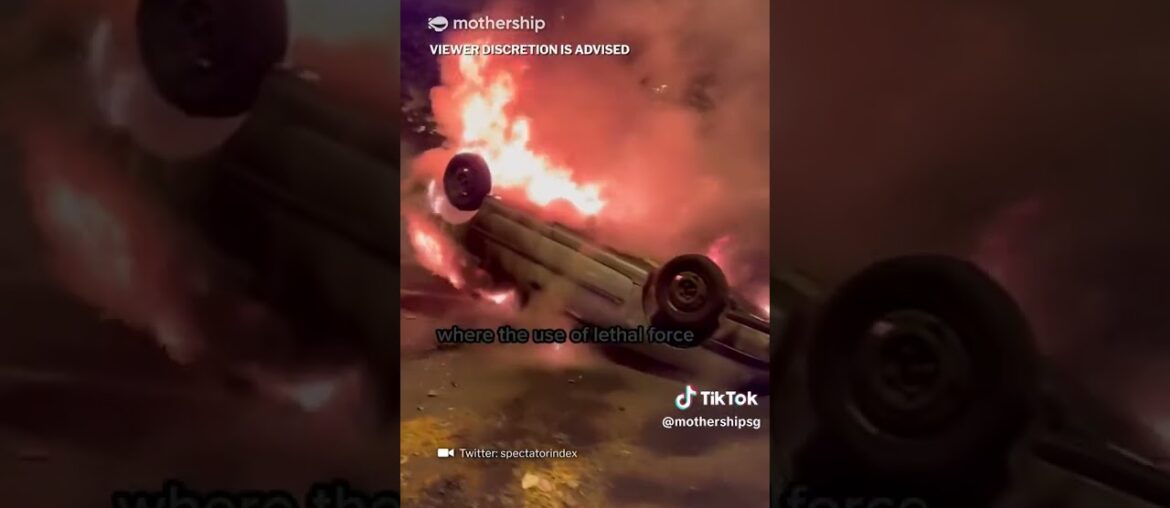 Man eats sandwich while rioters & police clash in Nanterre, France