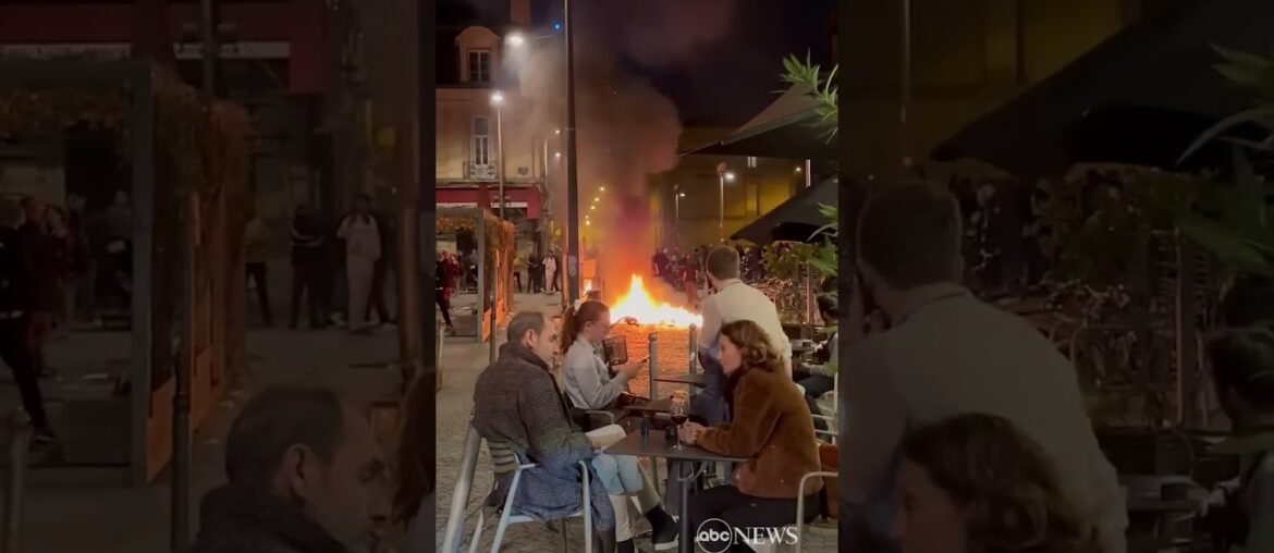 french diners enjoy wine as fire lit by protesters burns nearby abc news #shorts
