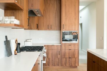 walnut cabinets blending into open shelving