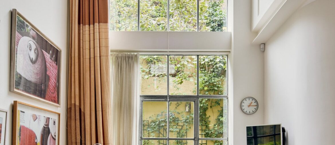 Reception area with tall ceilings in a converted warehouse apartment, East London, UK [1600x2400]