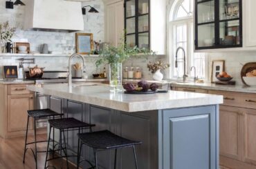 Renovated kitchen with arched sink window and glass door cabinets, West University Place, Texas