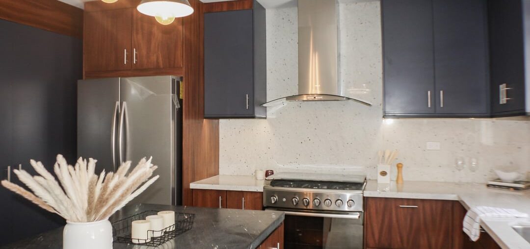 How do you feel about this design? Beautiful parota wood and Indigo- blue cabinets + combination of black leathered and white granite countertops.