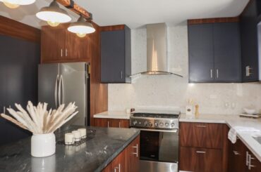 How do you feel about this design? Beautiful parota wood and Indigo- blue cabinets + combination of black leathered and white granite countertops.