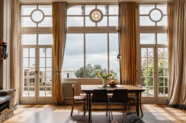 Living room opening up to a balcony overlooking the English Channel in a four-bedroom Victorian house built into the white cliffs of Ramsgate, Kent, England [1500x1000]