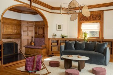 Fireplace nook in the living room of a renovated 1884 Queen Anne Victorian house with restored and cleaned original woodwork in the Boston suburbs, Massachusetts [2500x1667]