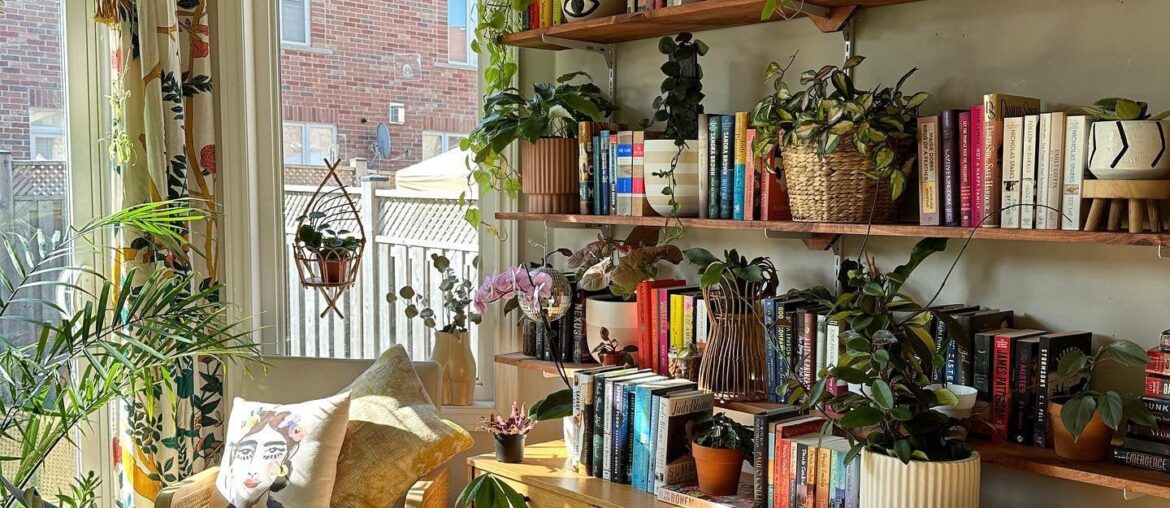 Reading corner surrounded with houseplants, Ontario, Canada [1440x1799]