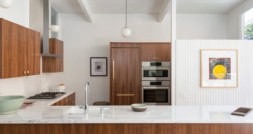 walnut cabinetry, copper handles, white marble countertops