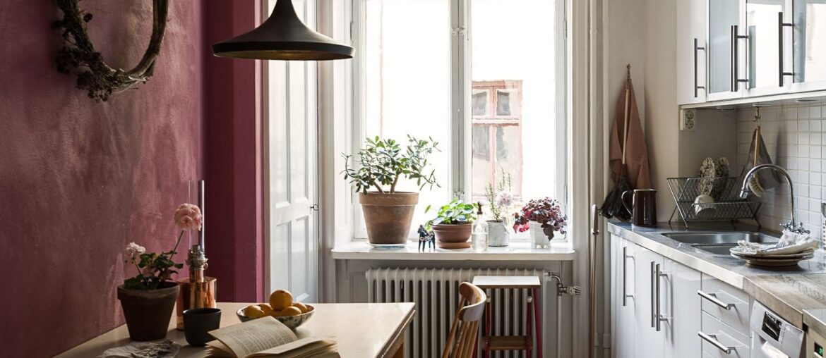 Long and narrow kitchen with a checkerboard pattern tiled floor in a 1906 apartment, Vasastaden, central Stockholm, Sweden [1499x2000]