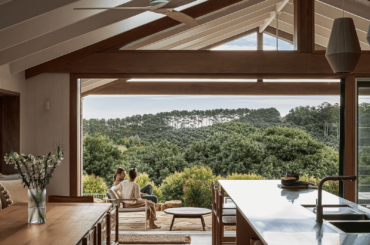 Breezy kitchen and dining space overlooking the lush landscape around Byron Bay, a beachside town in New South Wales, Australia