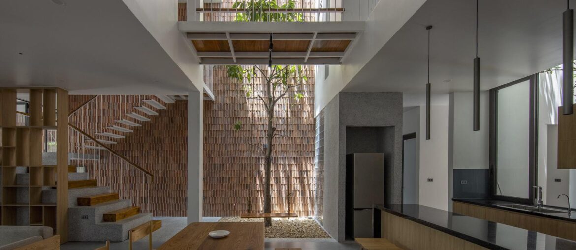 Open plan kitchen and dining with courtyard in NA House [1498 x 1000] Vietnam