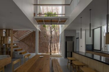 Open plan kitchen and dining with courtyard in NA House [1498 x 1000] Vietnam