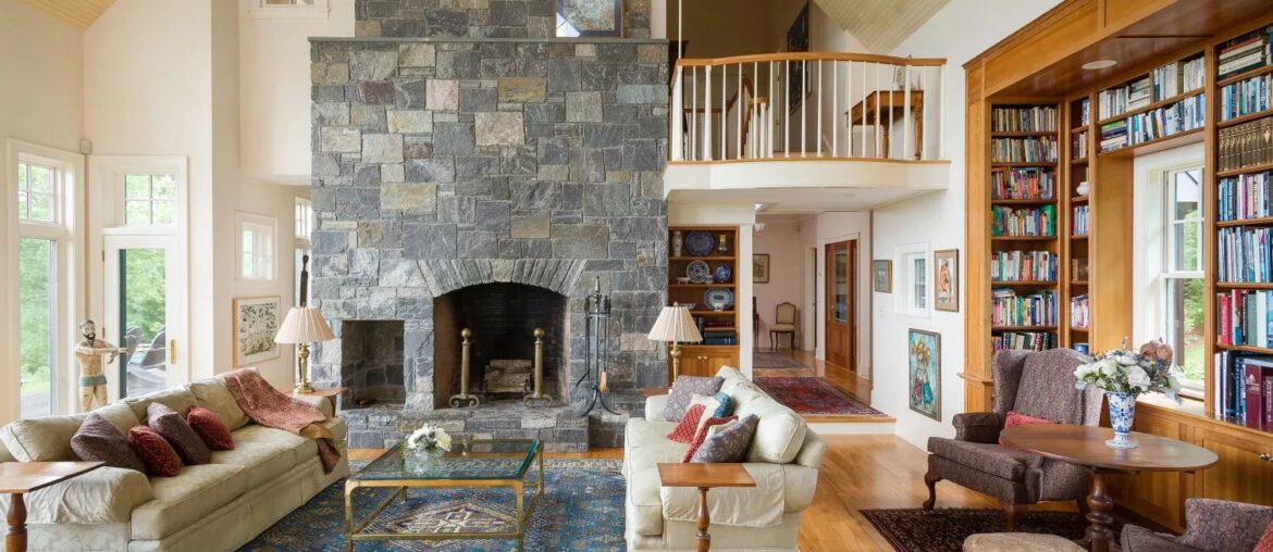 Tall living room with stone fireplace and book shelved window [1500x1000]