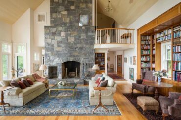 Tall living room with stone fireplace and book shelved window [1500x1000]