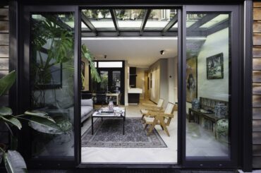 Newly renovated living room and kitchen with white oak parquet floors and mid-century modern furniture. By Studio Botanica [7503 × 5002]