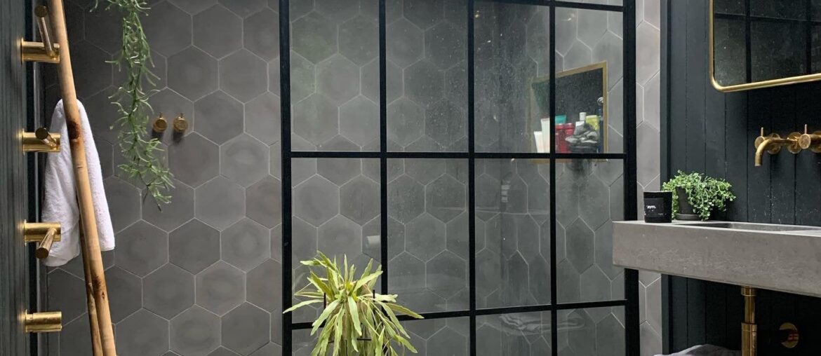 Bathroom with a skylight and a steel framed glass shower enclosure in a renovated 1930s home, Derbyshire, East Midlands, England [1440x1800]
