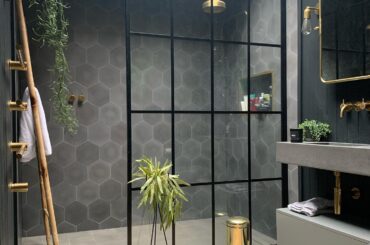 Bathroom with a skylight and a steel framed glass shower enclosure in a renovated 1930s home, Derbyshire, East Midlands, England [1440x1800]