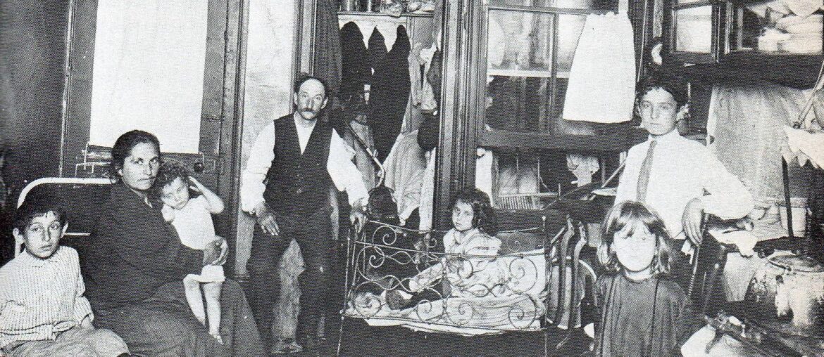 Italian immigrant family in combination kitchen/living quarters NYC, 1900.
