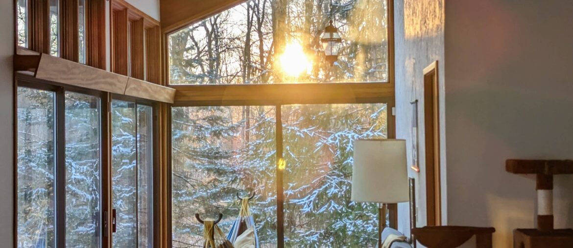 Sunset aligned with the sunroom in our mid century modern Deck House [3061x4066]