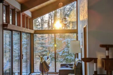 Sunset aligned with the sunroom in our mid century modern Deck House [3061x4066]