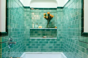 Turquoise tile-clad shower and bathtub alcove with a skylight in a renovated 1936 Spanish bungalow, Los Angeles [1706x2560]