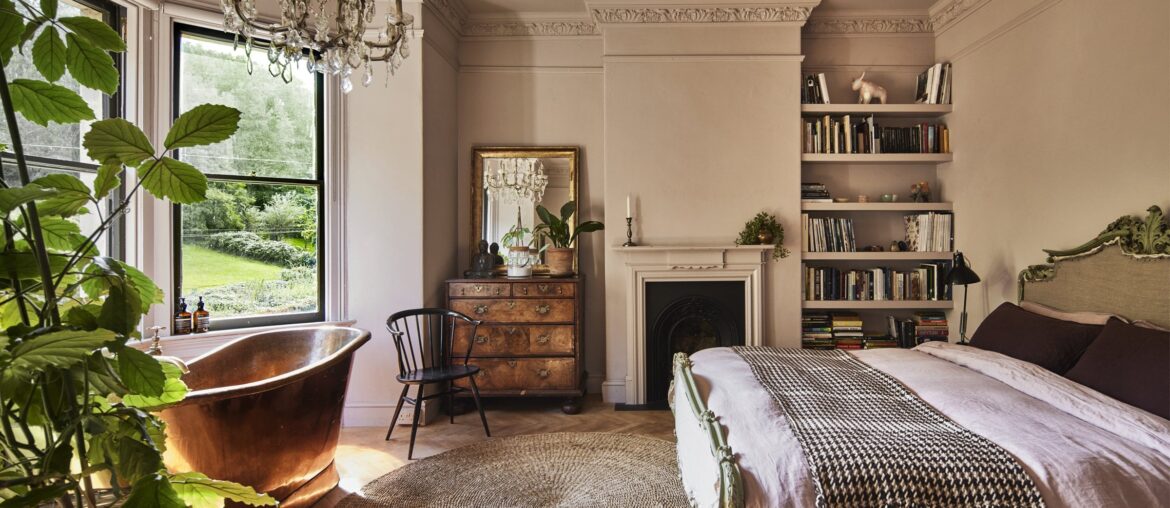 Main bedroom with a brass bateau tub set into the bay window in a restored and renovated Victorian villa, Lyncombe Vale, Bath, Somerset, England [2400x1601]