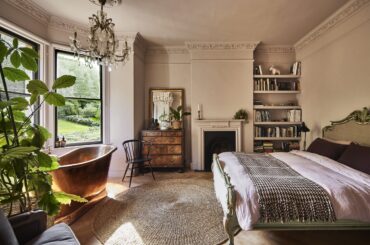 Main bedroom with a brass bateau tub set into the bay window in a restored and renovated Victorian villa, Lyncombe Vale, Bath, Somerset, England [2400x1601]